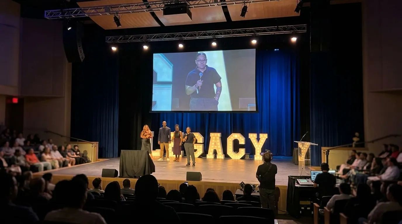 Crystal speaking on stage at a Legacy event
